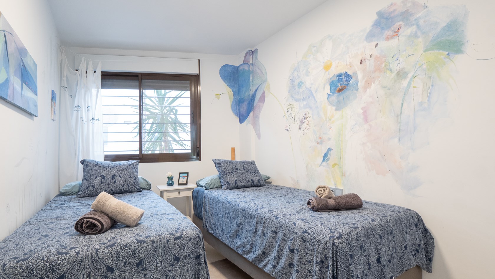 Bedroom with an original wall mural at Casa Divan